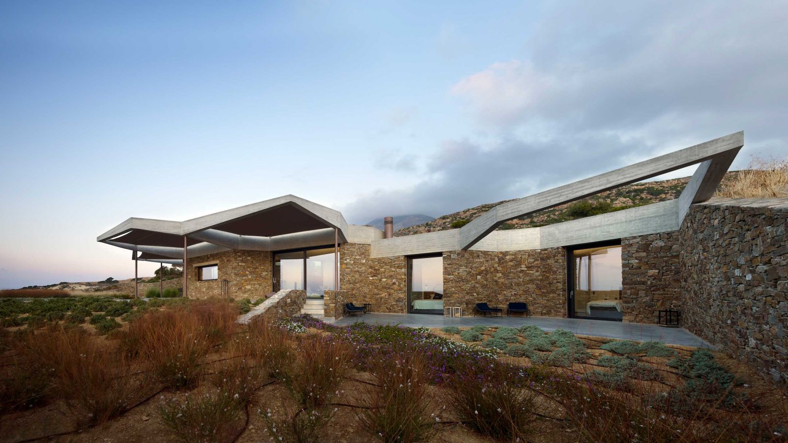 Die Dächer ergeben ein Muster, das die zugrunde liegende Entwurfsstrategie anschaulich darstellt und gleichzeitig dafür sorgt, dass sich das Wohngebäude in die Landschaft einfügt.