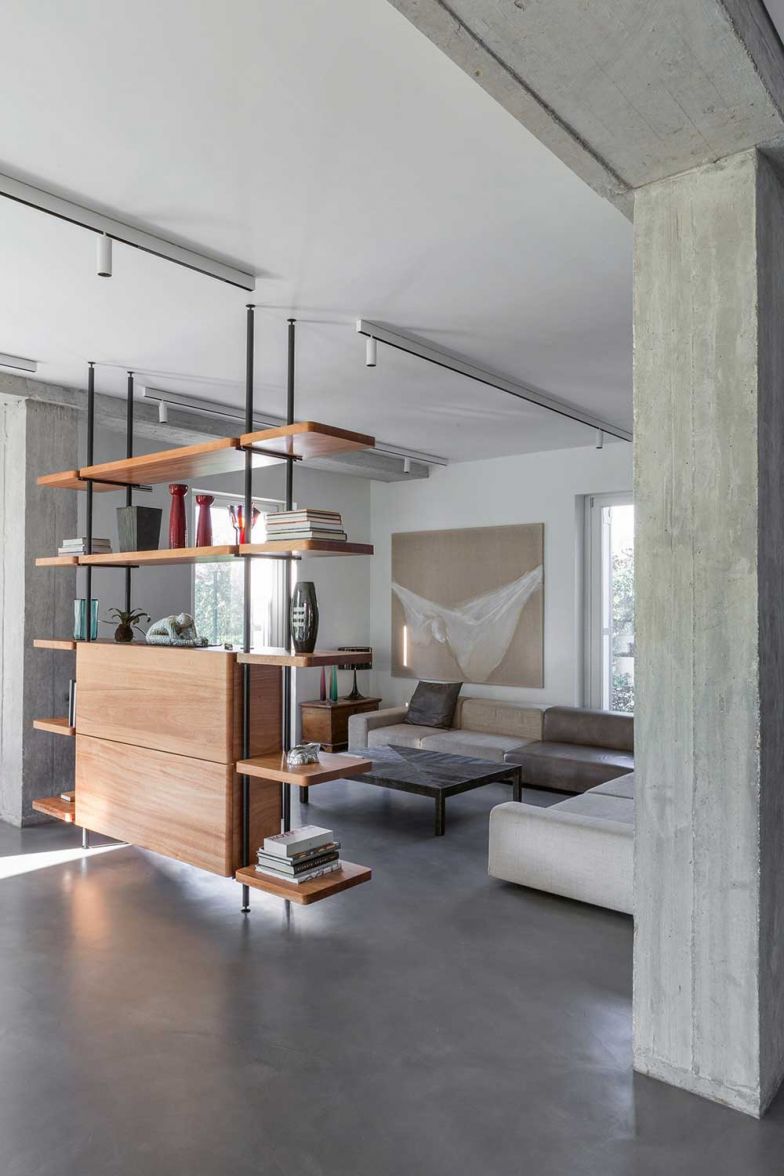 Der TV-Bereich ist durch deckenhohe Regale (ein Entwurf der Architekten) vom restlichen Raum abgetrennt. Das Sofa hat Piero Lissoni für Living Divani gestaltet. 