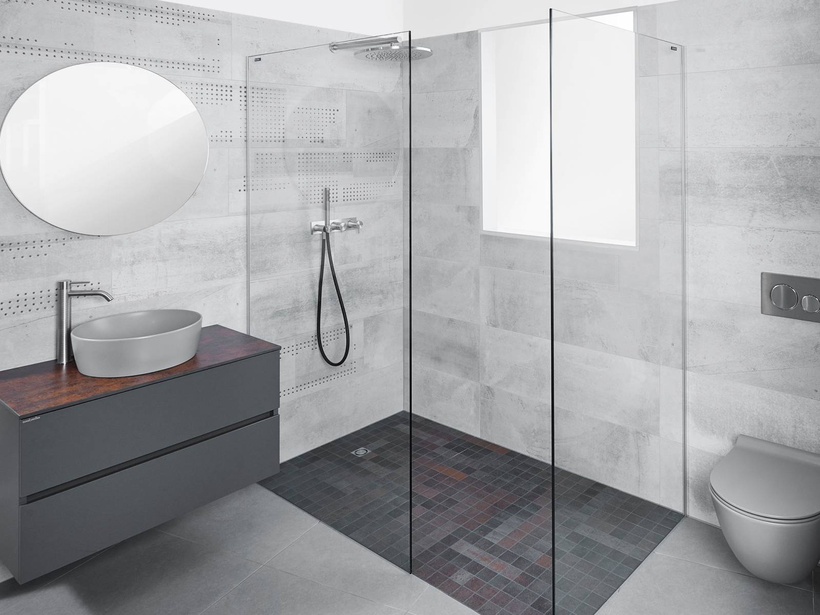 So unterschiedlich die Grautöne von Wänden, Wandklosett, Aufsatzwaschbecken und Bodenbelag sind, so gut lassen sie sich zu einem einheitlichen Bild zusammenfügen. Die Erdtöne der Keramikplatten im Duschbereich unterstreichen die exklusive Optik. SabagSo unterschiedlich die Grautöne von Wänden, Wandklosett, Aufsatzwaschbecken und Bodenbelag sind, so gut lassen sie sich zu einem einheitlichen Bild zusammenfügen. Die Erdtöne der Keramikplatten im Duschbereich unterstreichen die exklusive Optik. Sabag.