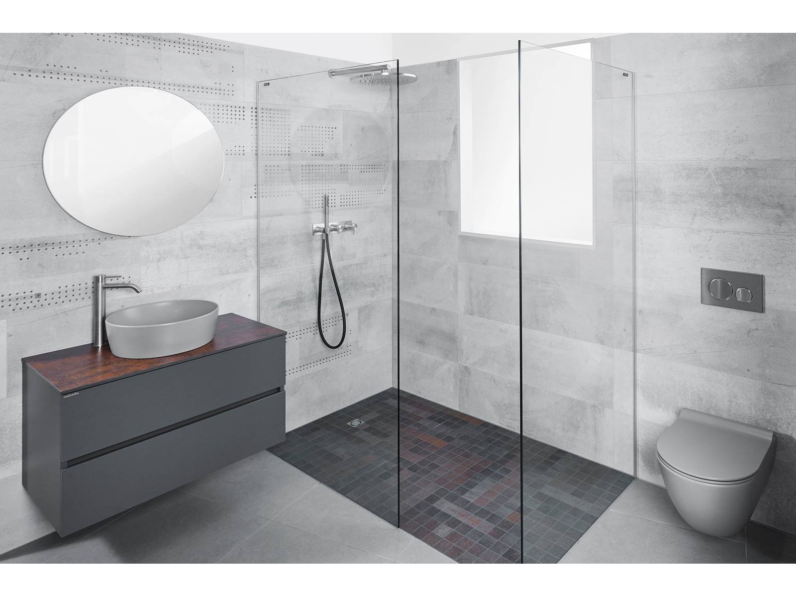 So unterschiedlich die Grautöne von Wänden, Wandklosett, Aufsatzwaschbecken und Bodenbelag sind, so gut lassen sie sich zu einem einheitlichen Bild zusammenfügen. Die Erdtöne der Keramikplatten im Duschbereich unterstreichen die exklusive Optik. SabagSo unterschiedlich die Grautöne von Wänden, Wandklosett, Aufsatzwaschbecken und Bodenbelag sind, so gut lassen sie sich zu einem einheitlichen Bild zusammenfügen. Die Erdtöne der Keramikplatten im Duschbereich unterstreichen die exklusive Optik. Sabag.