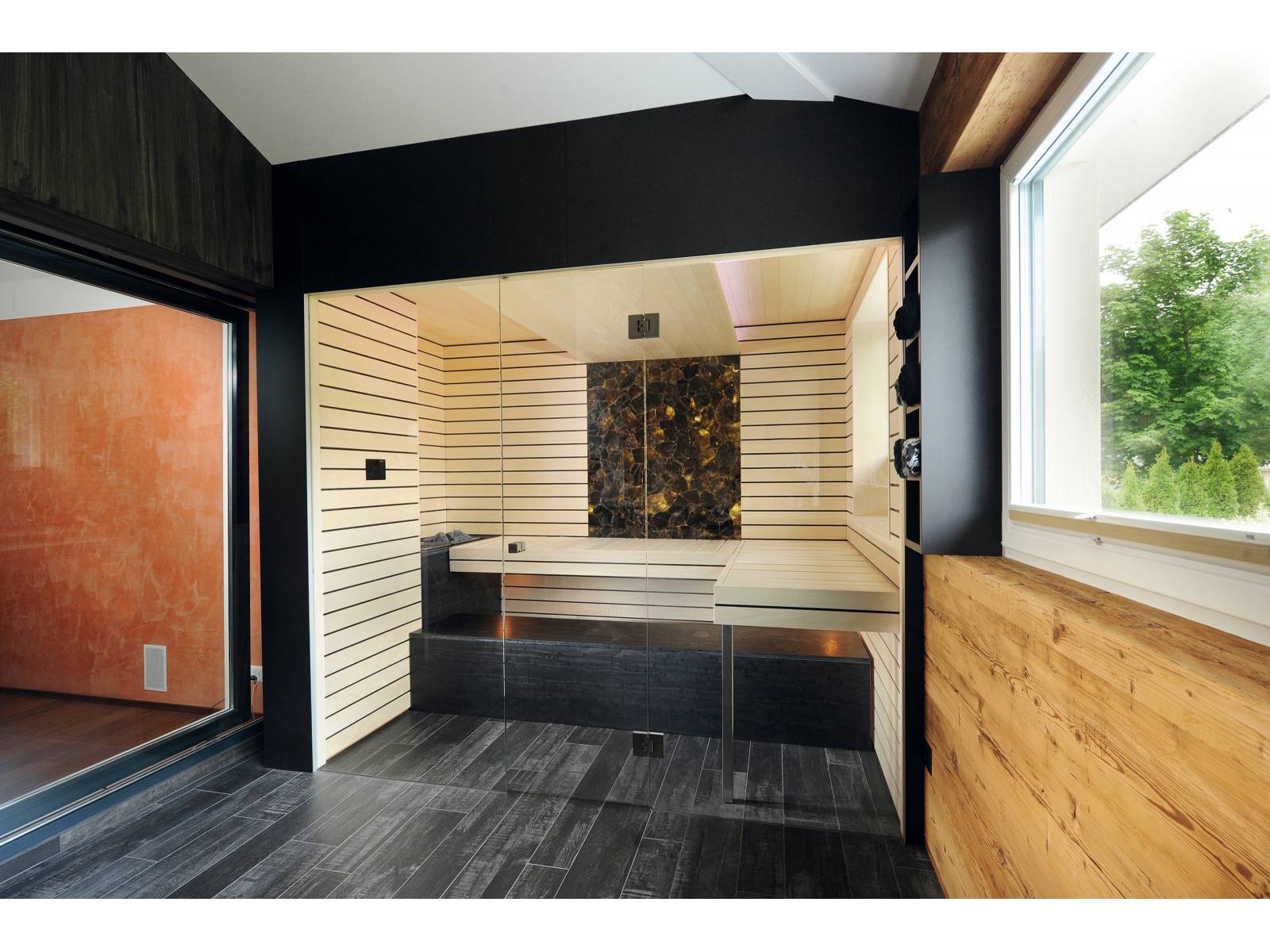 Der Saunabauer hat in diesem Beispiel aus einer Terrasse einen Wellnessbereich geschaffen. Hauptteil ist die Sauna aus heller Espen-Täfelung mit integriertem Biosa-Ofen. Verborgene Lichtquellen, bequeme Liegeflächen und ein hinterleuchteter Rauchquarz als Blickfang machen diesen Ort zu einer Wohlfühloase. Küng Sauna.