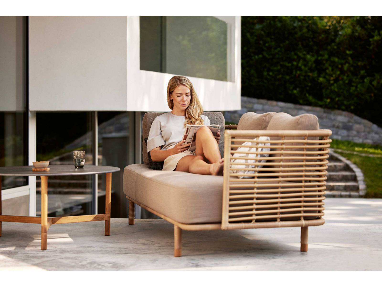 Das dänische Designerpaar Foersom &amp; Hiort-Lorenzen hat mit «Sense Outdoor» einen eleganten und zugleich skulpturalen Dreisitzer aus dem Naturmaterial Rattan entworfen. Bewegliche, schnell trocknende Rückenkissen erlauben es, bequem Platz zu nehmen und zu entspannen. CANE-LINE.