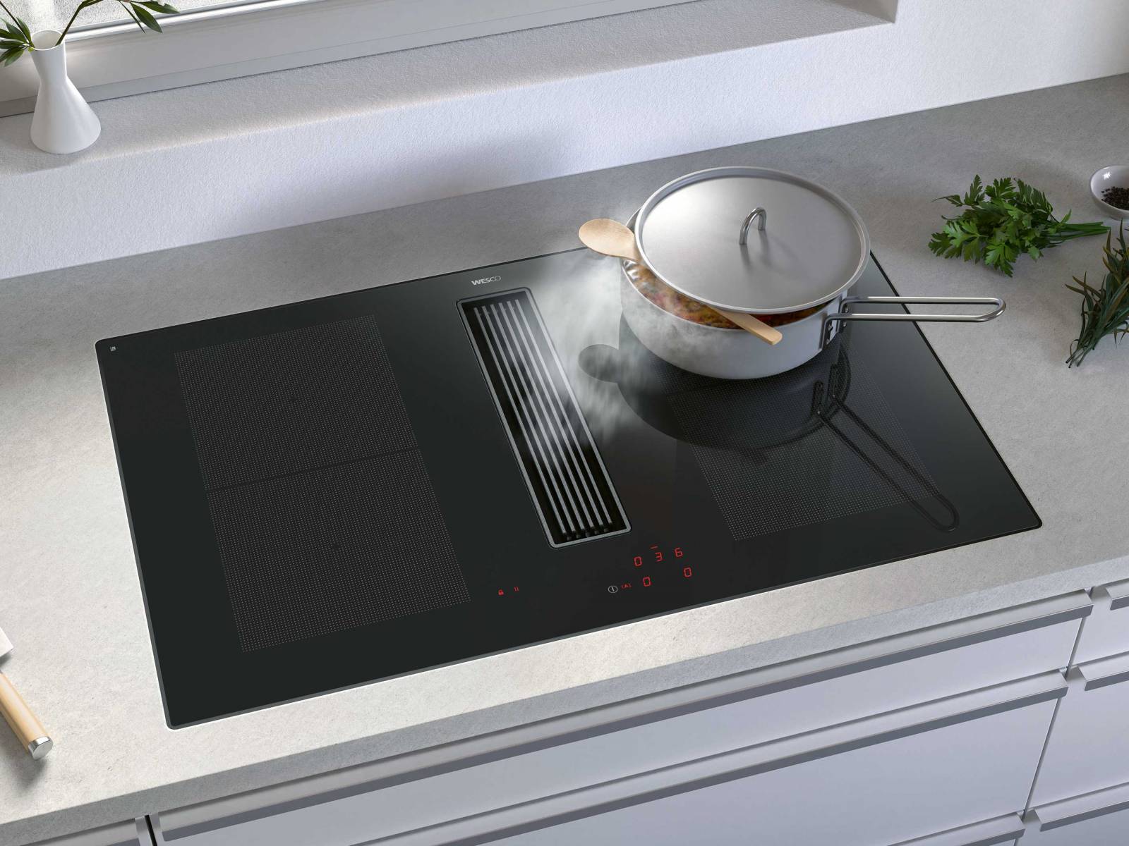 Wer es minimalistisch mag und auf eine sperrige Dunstabzugshaube verzichten will, dem sei «Piana» ans Herz gelegt. Hier kommt der Dunstabzug direkt im Induktionskochfeld daher, das rahmenlos in die Küchenabdeckung eingebaut werden kann. Zur Auswahl stehen die Modelle «Piana Compact» und «Piana Start» (im Bild). WESCO.