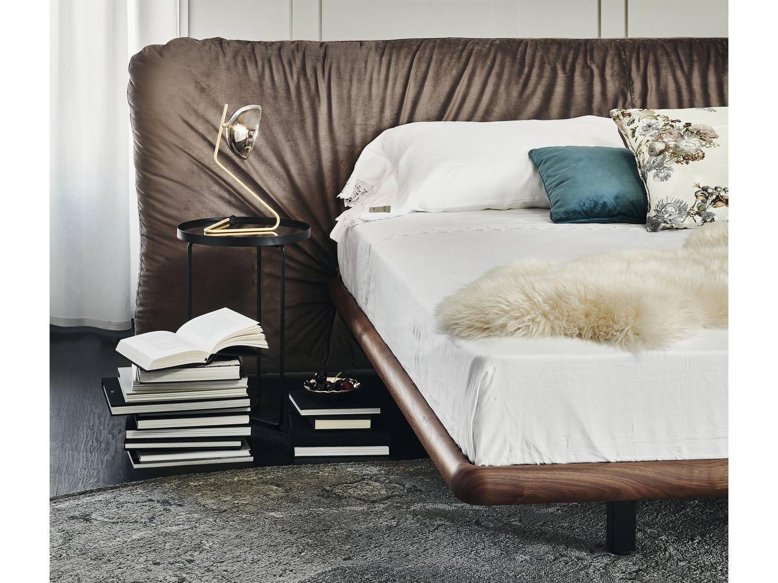 Fast wie ein Schutzschild ummantelt das grosszügige Kopfteil das Bett «Marlon», dessen Gestell aus Nussbaum, Esche oder Eiche vergleichsweise feingliedrig wirkt. Für den einladenden Faltenwurf des Kopfteils erweiterte der italienische Hersteller sein Portfolio um neue Stoffe und Leder. Cattelan.