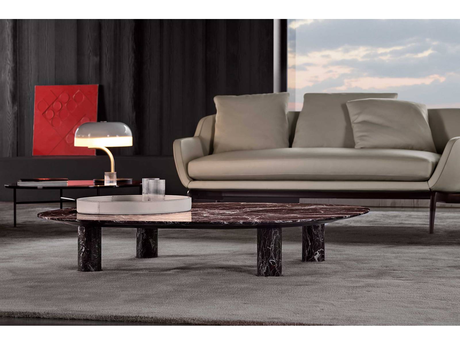 «Gladstone» ist vom Design der 1970er-Jahren inspiriert: Vier massive zylindrische Beine tragen eine ovale Platte, die dank ihrer Ausbuchtung nahezu filigran wirkt. Der Beistelltisch ist aus Marmor gefertigt und entfaltet seine ästhetische Kraft dank einer speziellen Polierbehandlung, die ihn matt und seidig macht. Die Marmorarten wie Rosso Levanto sind so ausgewählt, dass sie sich gut mit den anderen Möbeln des Herstellers kombinieren lassen. Design: Rodolfo Dordoni. MINOTTI.